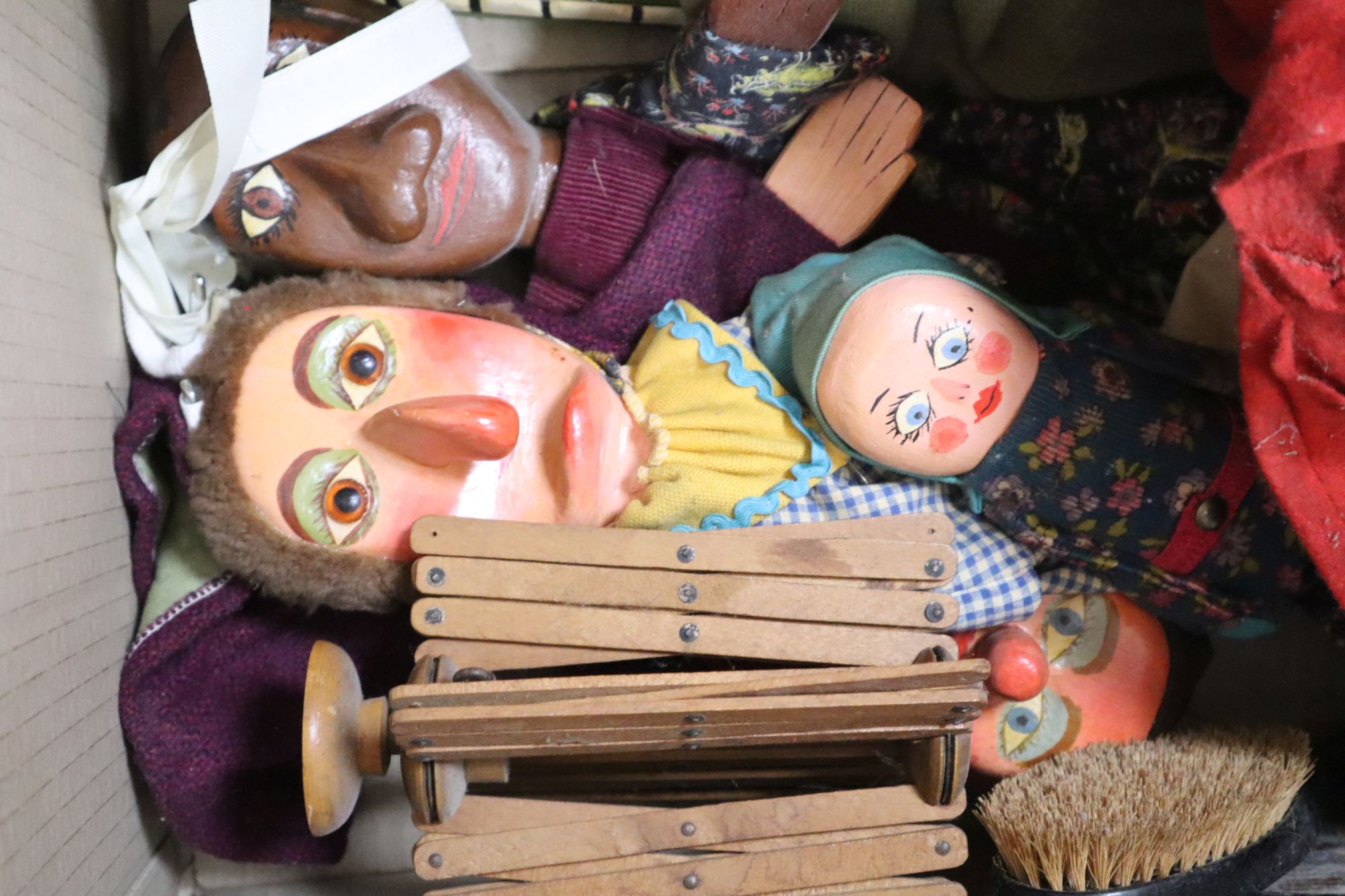 A group of Punch & Judy painted wood hand puppets other collectables and fabrics